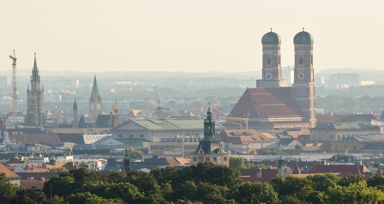 Hazy city skyline with twin-towered Frauenkirche and gothic spires rising above rooftops