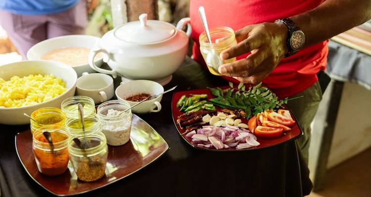 A table with various ingredients and spices ready for cooking.