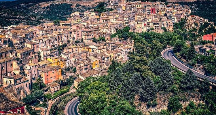 Vue panoramique d'une ville de colline aux constructions colorées.