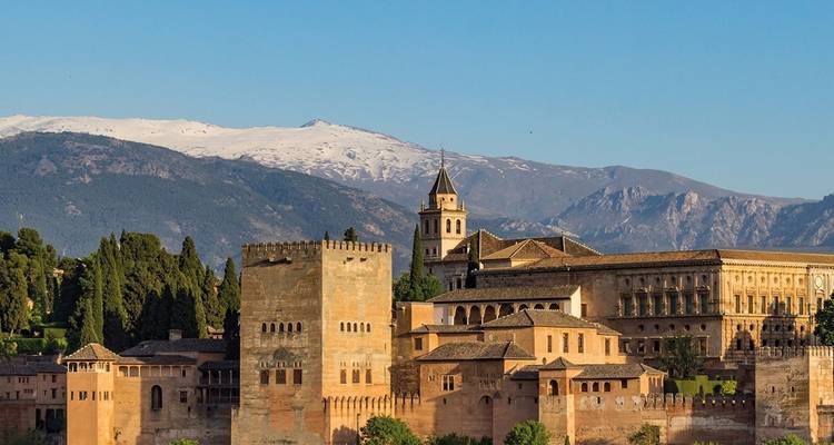 Alhambra fortress with snowy mountains in the background.