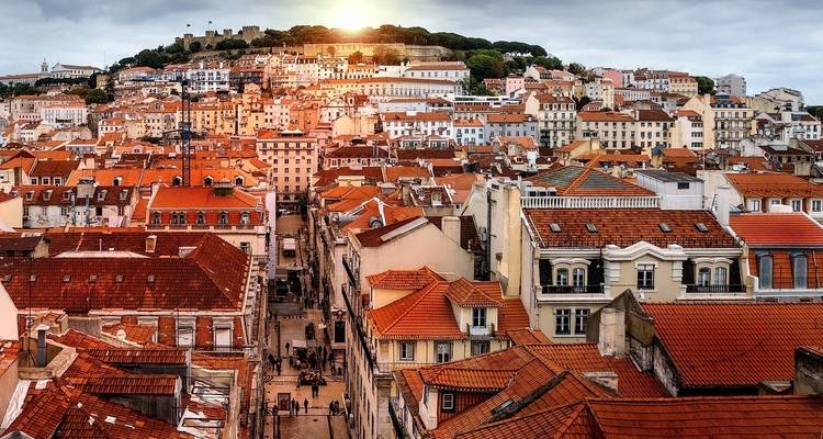 Cityscape view from above with red rooftops.