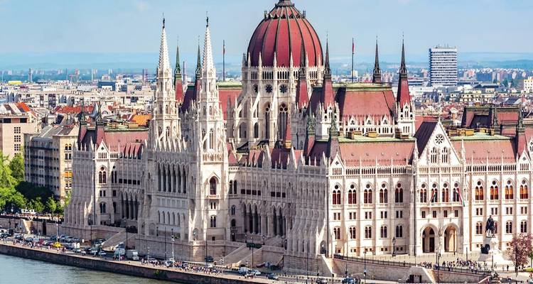 Iconic Hungarian Parliament Building lining the Danube on a bright clear day.