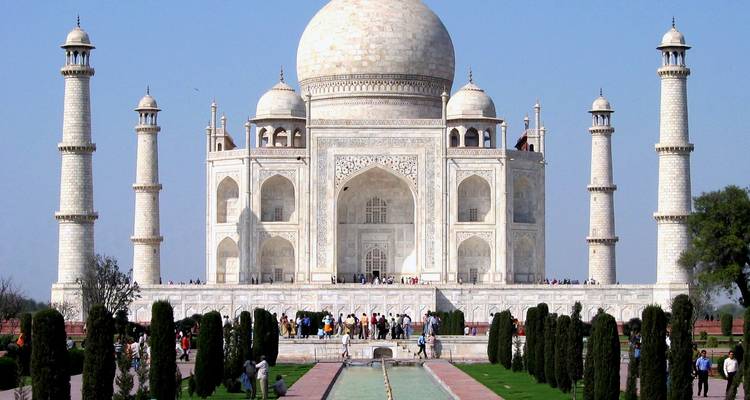 Iconic Taj Mahal with gardens and a large pool in front.
