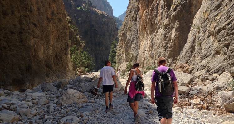 Los excursionistas recorren el lecho rocoso de un espectacular cañón estrecho con paredes de piedra caliza que se alzan imponentes