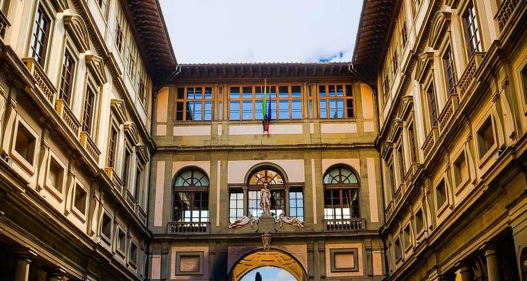 Interior view of historic architecture with archway and windows.