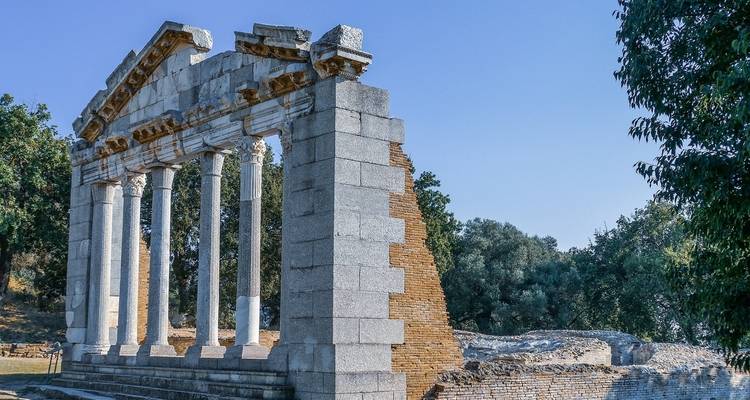 Ruins of ancient columns set against a clear sky.