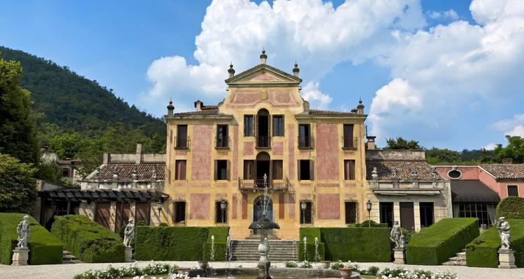 Historische Villa umgeben von gepflegten Gärten.