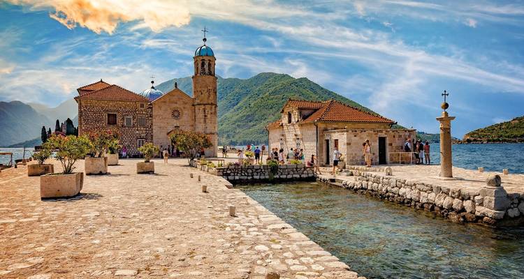 Scène côtière avec église historique en pierre et structures environnantes.