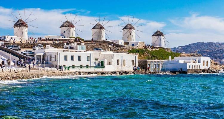 Famous windmills on a coastal hill along the sea.