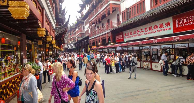 Une rue commerçante animée avec une architecture chinoise traditionnelle.