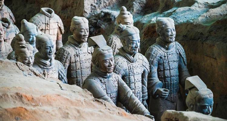 Primer plano de los rangos del Ejército de Terracota, destacando detallados guerreros de piedra en su pozo de excavación.