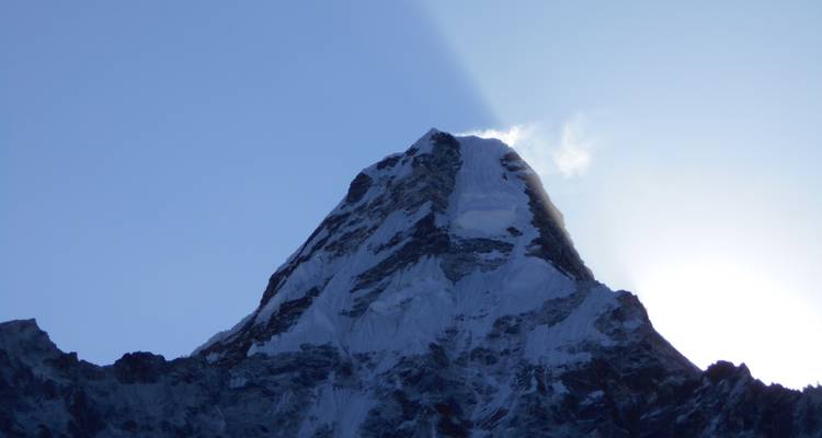 Snow-covered peak with dramatic shadow effect.
