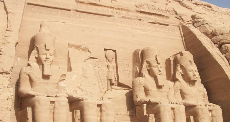 Large statues carved into a cliffside.