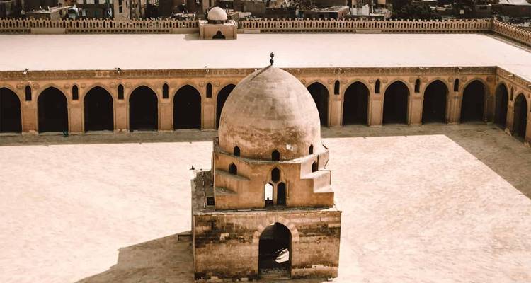 Historical mosque courtyard with arches.