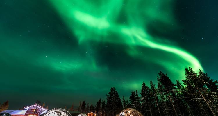 Northern lights over a snowy landscape