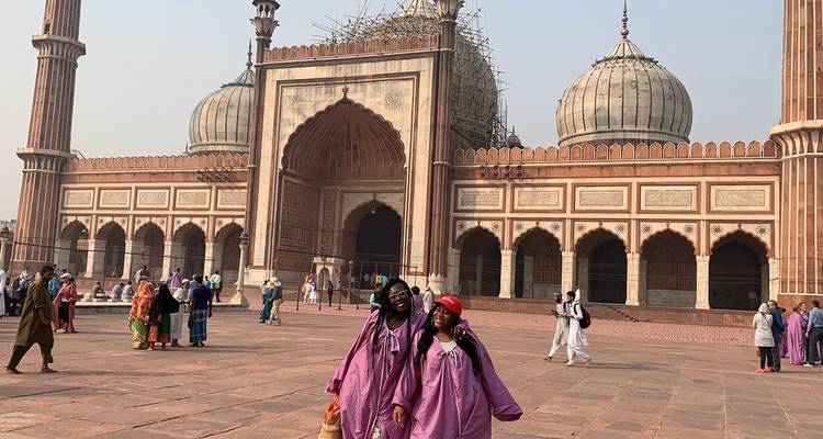Two women posing in front of Jama Masjid in New Delhi.