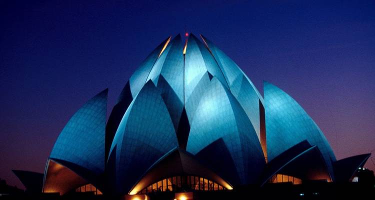 Lotus Temple at dusk with illuminated blue petals.