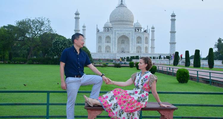 A couple posing in front of the Taj Mahal.