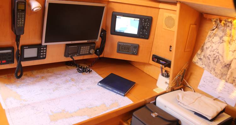 Boat navigation station with maps, devices, and other tools.