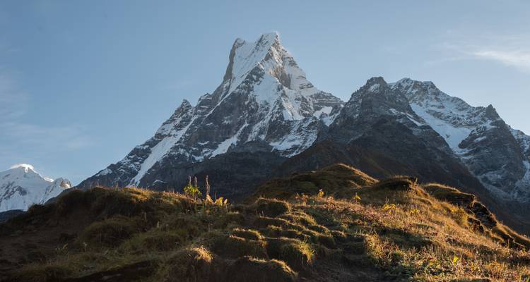 Clear view of Machapuchare mountain with sunlit foreground.