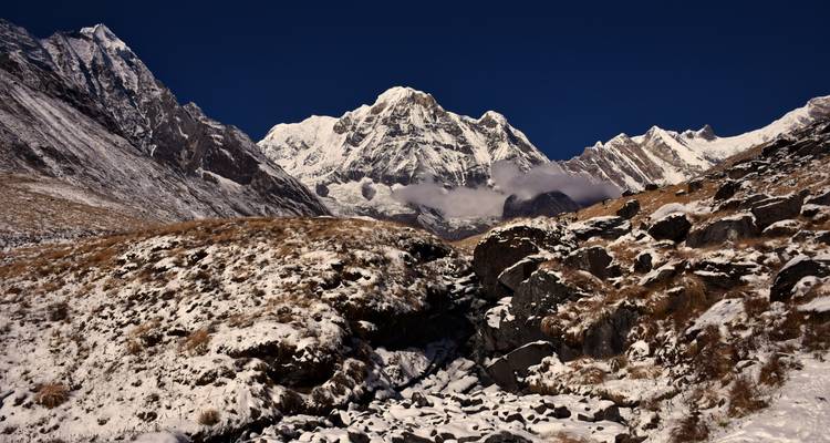 Snow-covered mountains with a clear sky.