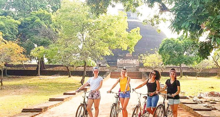 Groupe de touristes faisant du vélo près d'un site historique.