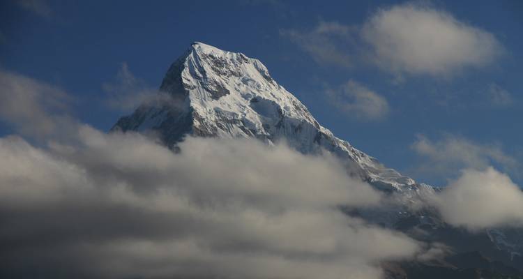 Snow-capped mountain peak against a blue sky.