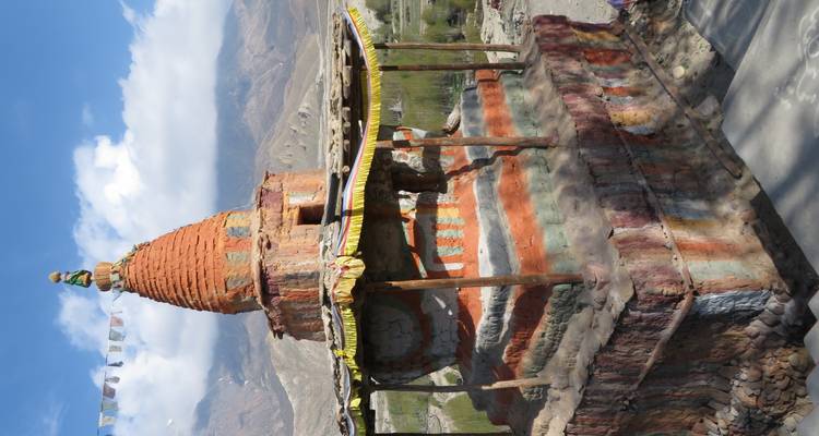 Een stupa in een bergachtig landschap.