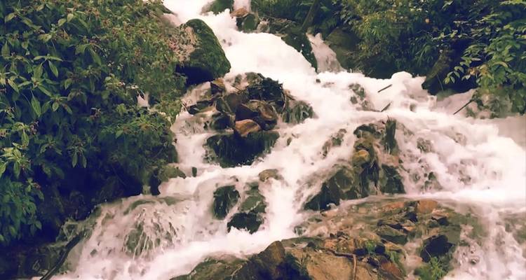 Close-up of a waterfall with rushing water over rocks.