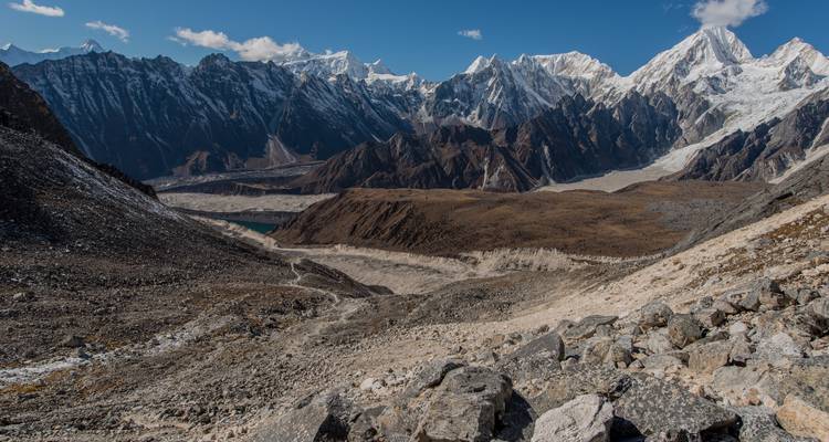 Expansive mountain range with snow-covered peaks and a rugged valley.
