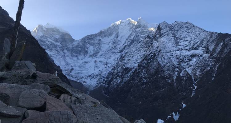 Snow-covered mountain peaks with clear sky.