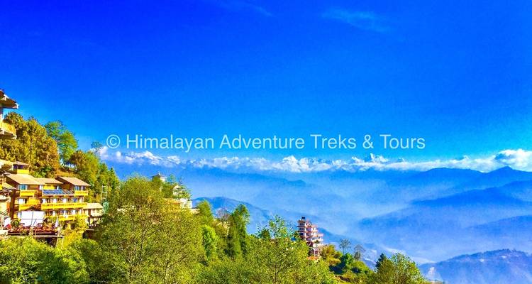 Mountain view with trees and sky, watermark present.