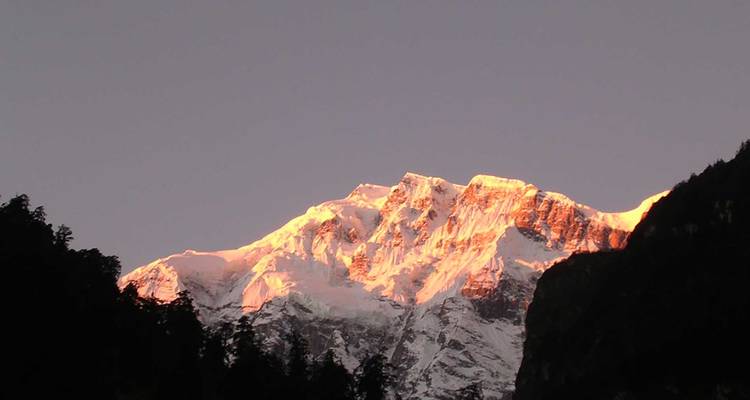 Mountain peaks illuminated by sunset light.