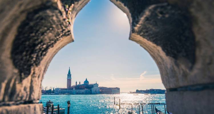 View of San Giorgio Maggiore from a stone arch.