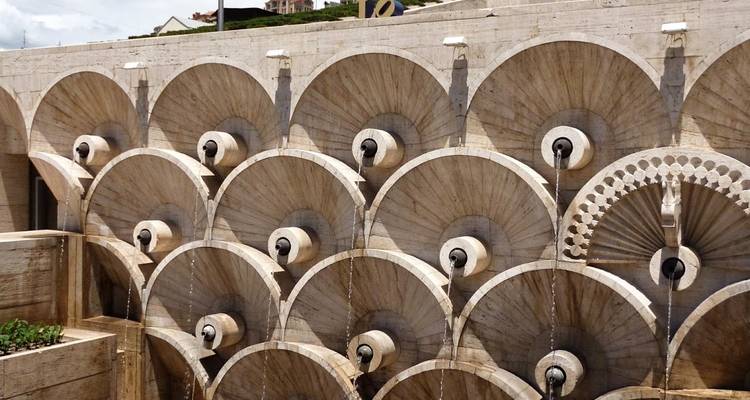 Intricate stone fountain with circular designs.