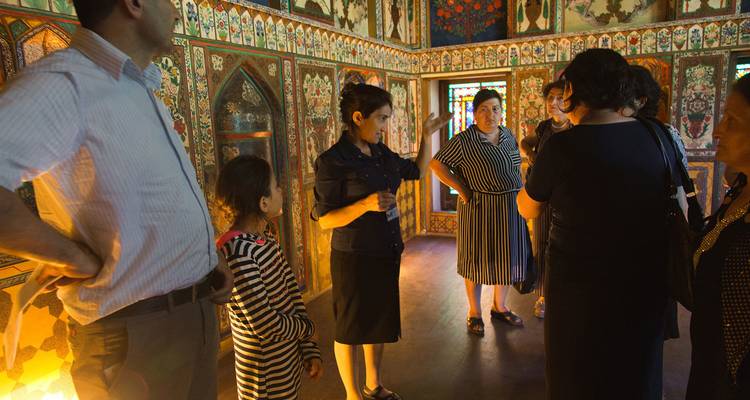Group of people inside a traditionally decorated room.
