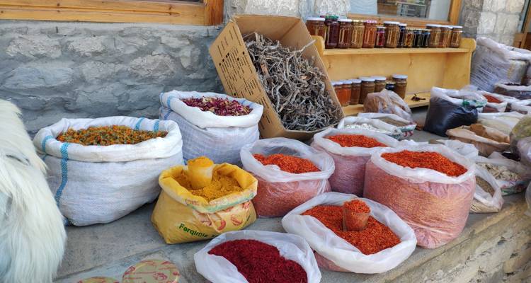 Variety of colorful spices in sacks on display.