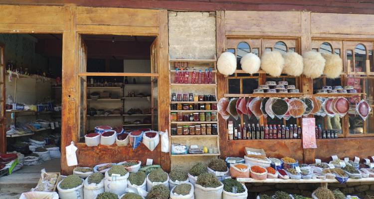 Market stall with various items, spices, and jars.