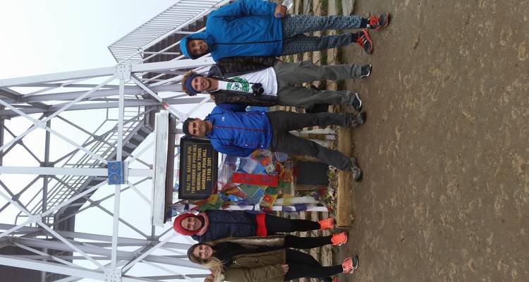 Group photo at a sign or tower.