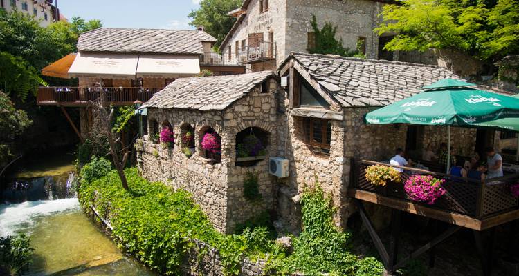Charming riverside buildings adorned with flowers.