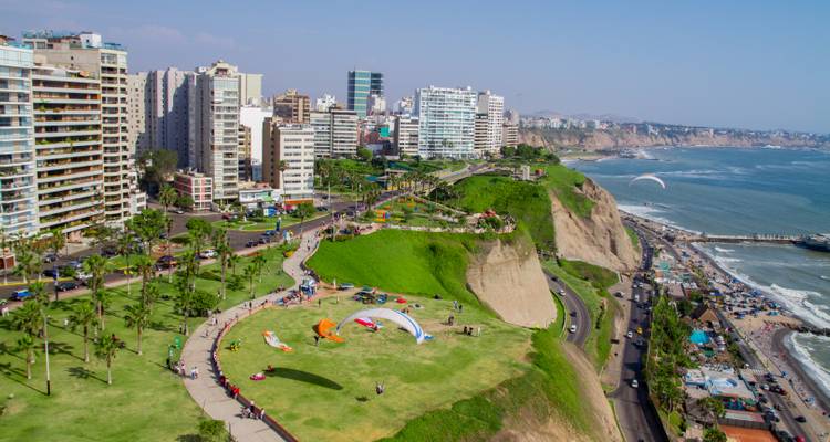 Clifftop park in Lima’s Miraflores district with paragliders soaring above the Pacific shoreline.