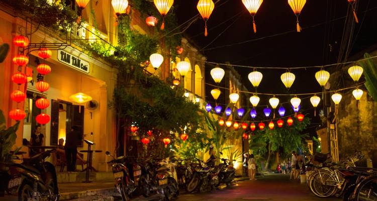 Street adorned with colorful lanterns and lively atmosphere in Hoi An.