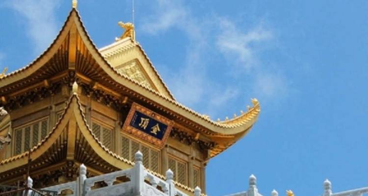 Gold and white traditional Chinese building with ornate roof.