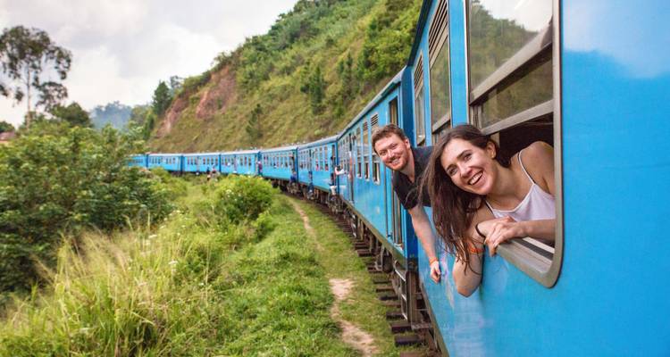 People on a scenic train ride with heads out the window.