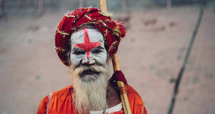 Portrait of a holy man with face paint and traditional attire.
