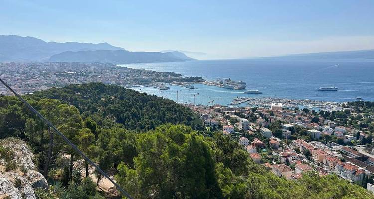 Panoramic view of a coastal city surrounded by mountains.