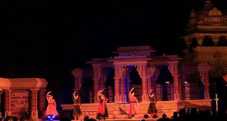 Nighttime performance with dancers on a lit stage.