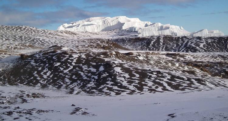 Snowy peak and rocky landscape.