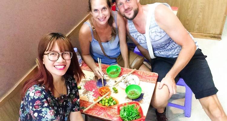 People enjoying a meal in a small restaurant.