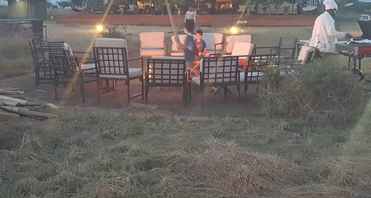 Outdoor seating area with a child and a person engaging in camp activities